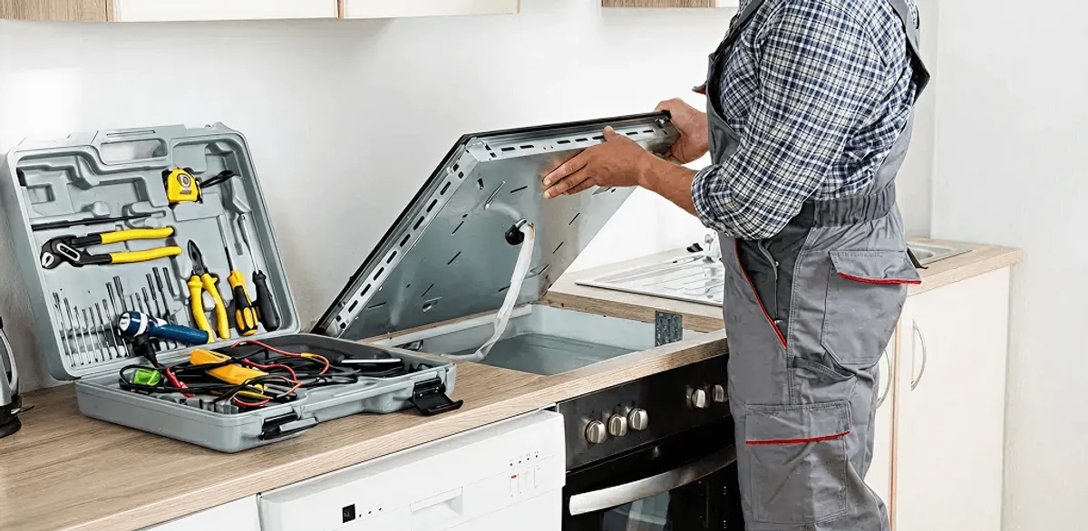 Handyman repairing a cooktop and checking wiring connections in West Palm Beach, FL