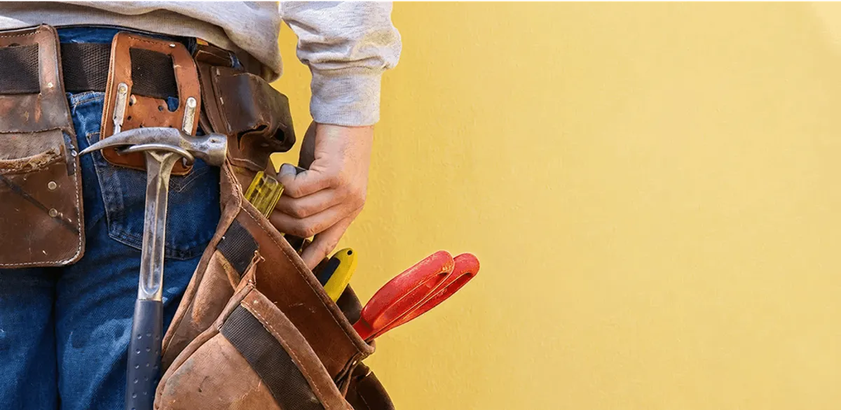 Handyman with tool belt ready for home repairs and maintenance in West Palm Beach, FL